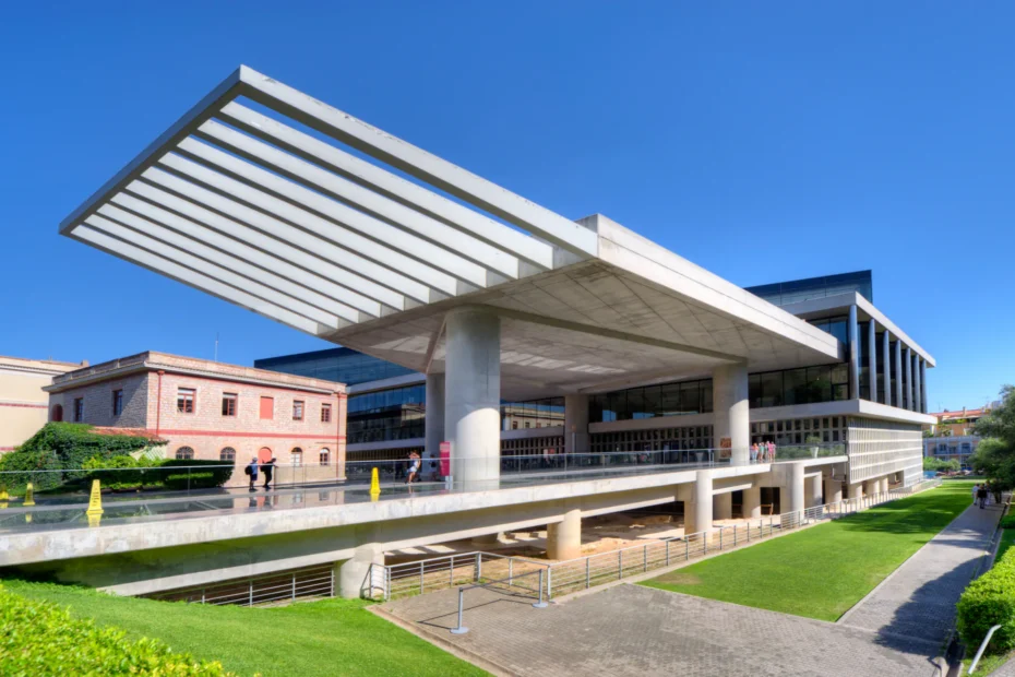 Modern exterior of the Acropolis Museum with glass and concrete architecture.