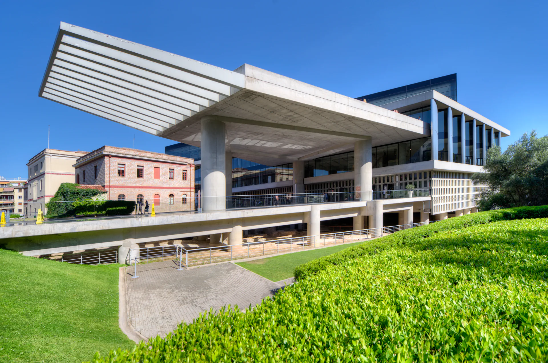 Modern exterior of the Acropolis Museum with glass and concrete architecture.