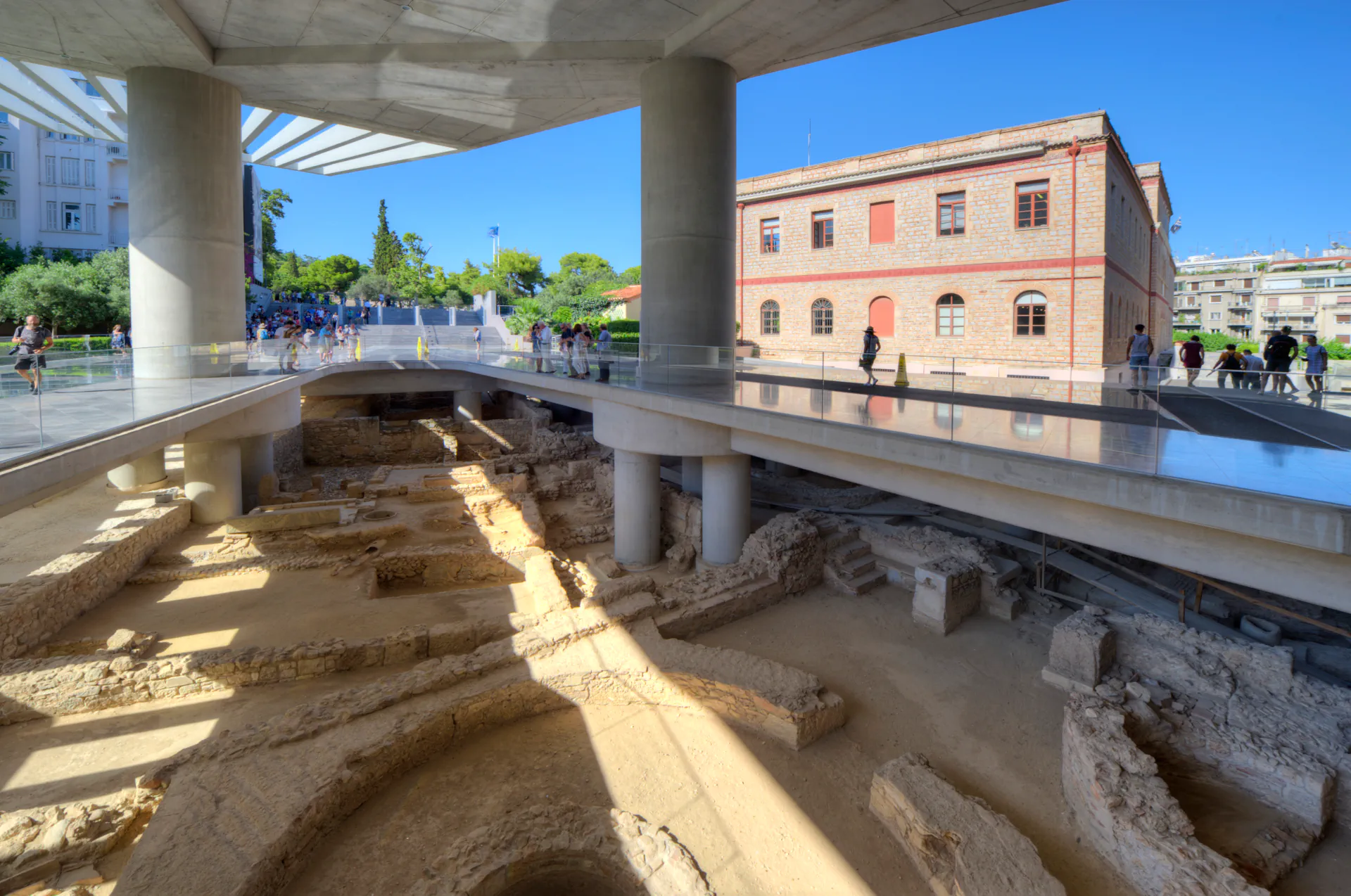 Outdoor view showing the museum’s elevated design over an archaeological site.