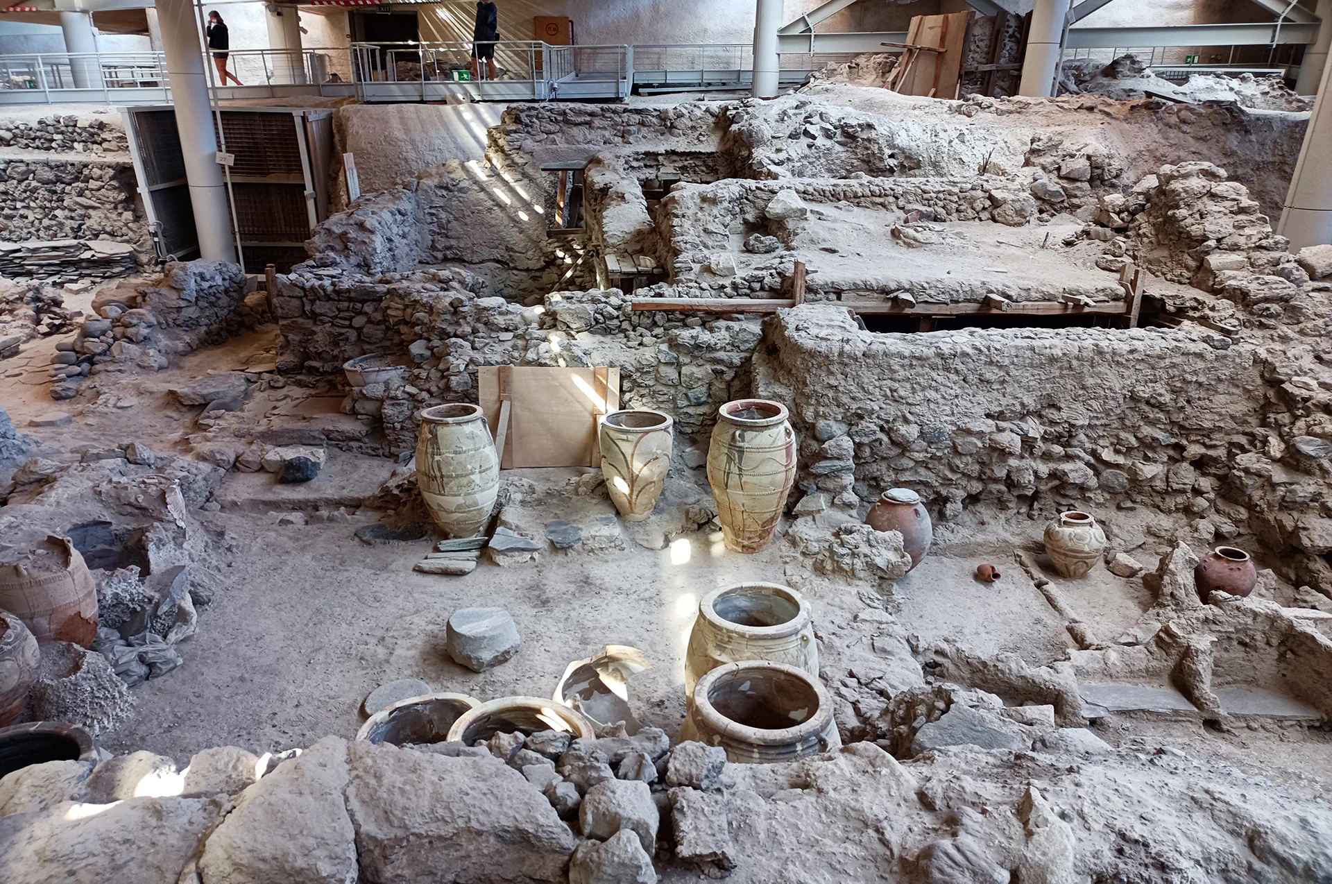 Ancient pottery and storage jars at Akrotiri ruins.