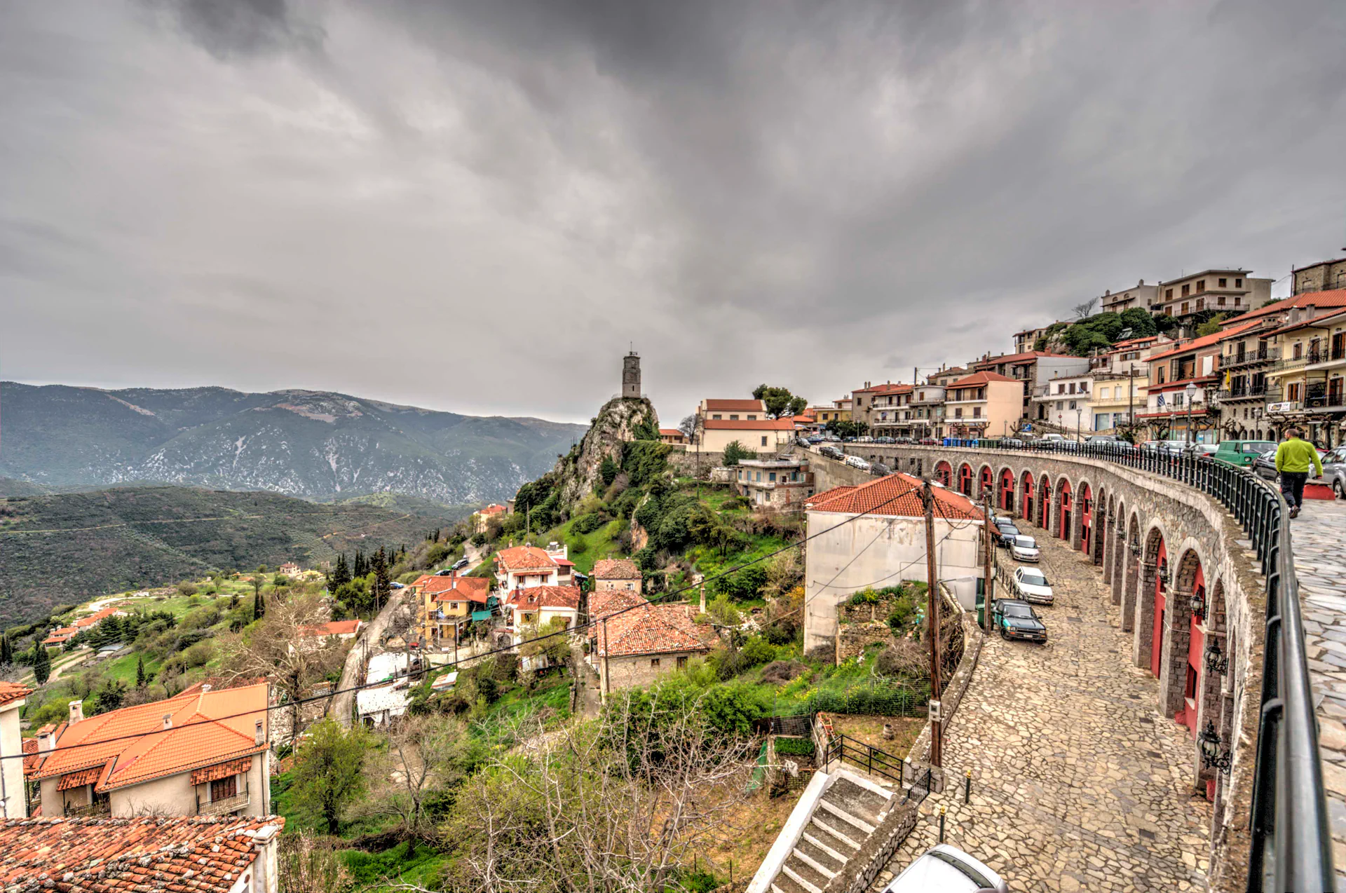 Traditional clock tower of Arachova under dark skies.