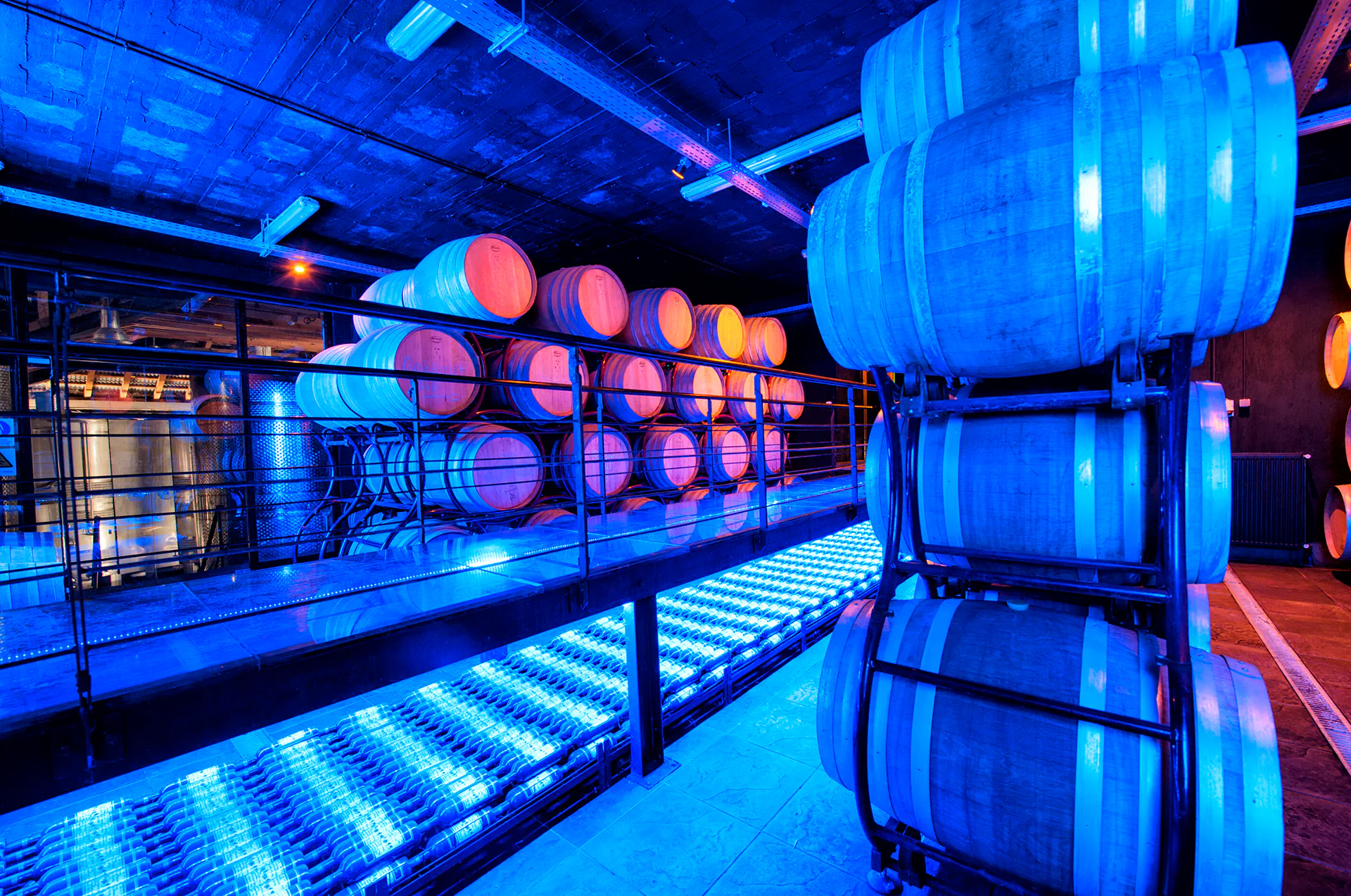 Barrel cellar at Katogi Averoff Winery with atmospheric lighting.