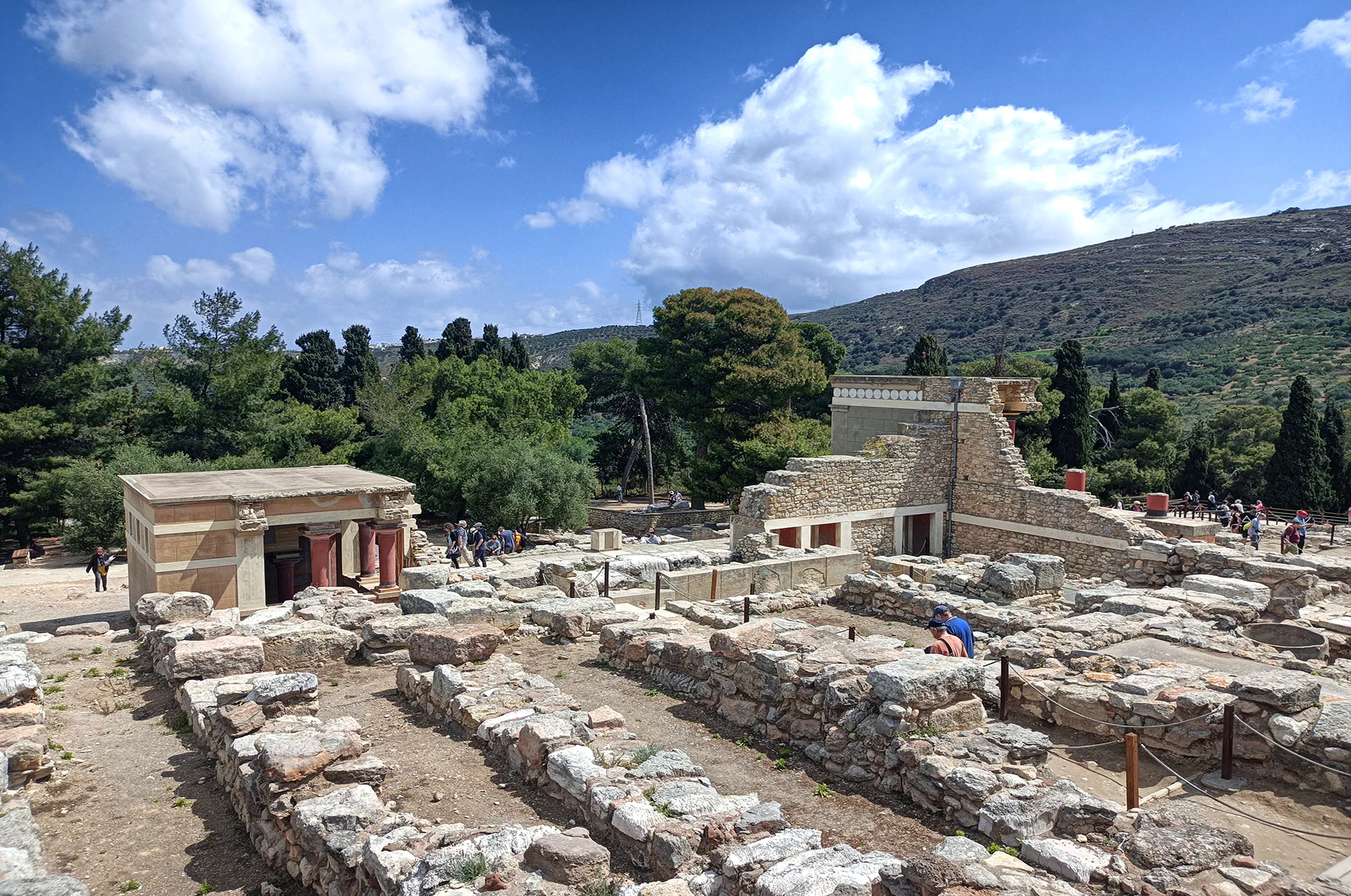 Visitors walking toward the reconstructed main entrance of Knossos palace.