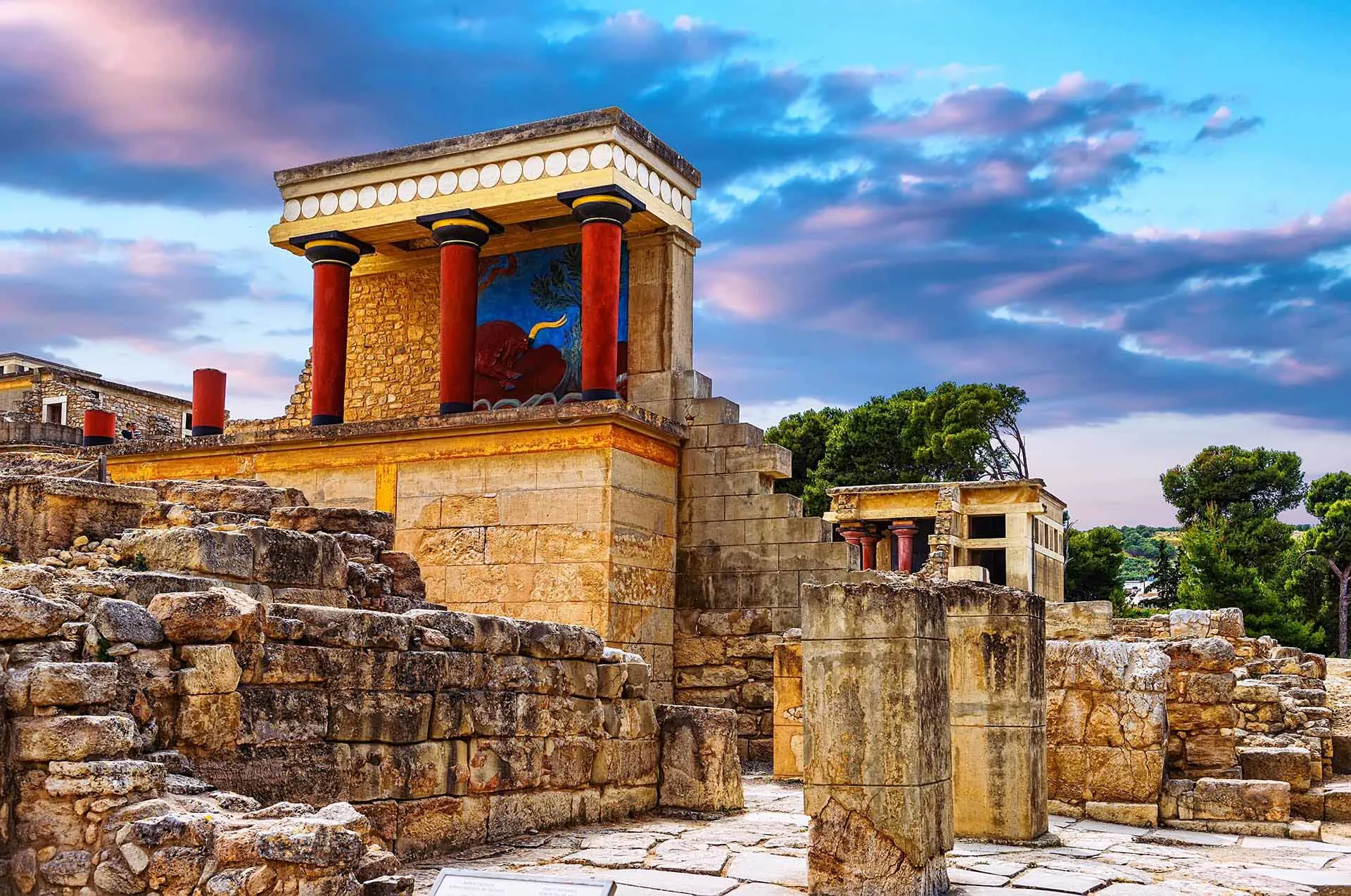 Bright red tapered columns with black capitals at the Minoan palace of Knossos.