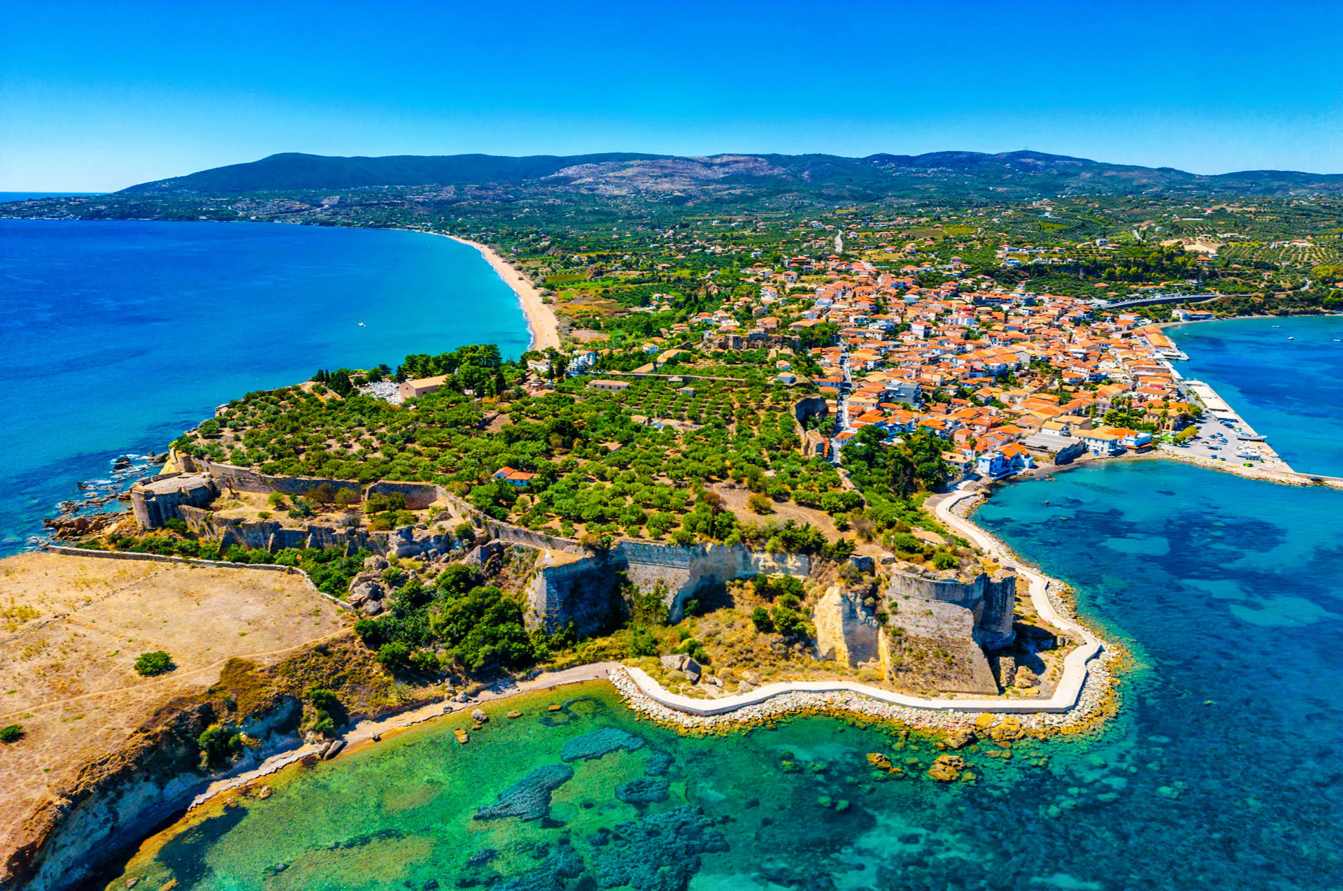 Koroni Castle on a hill with Koroni town and sea