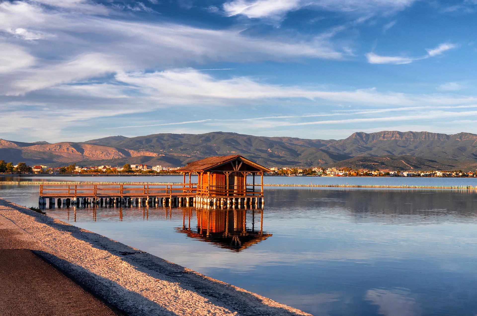 Scenic view of Mesolongi Lake with calm waters and surrounding greenery