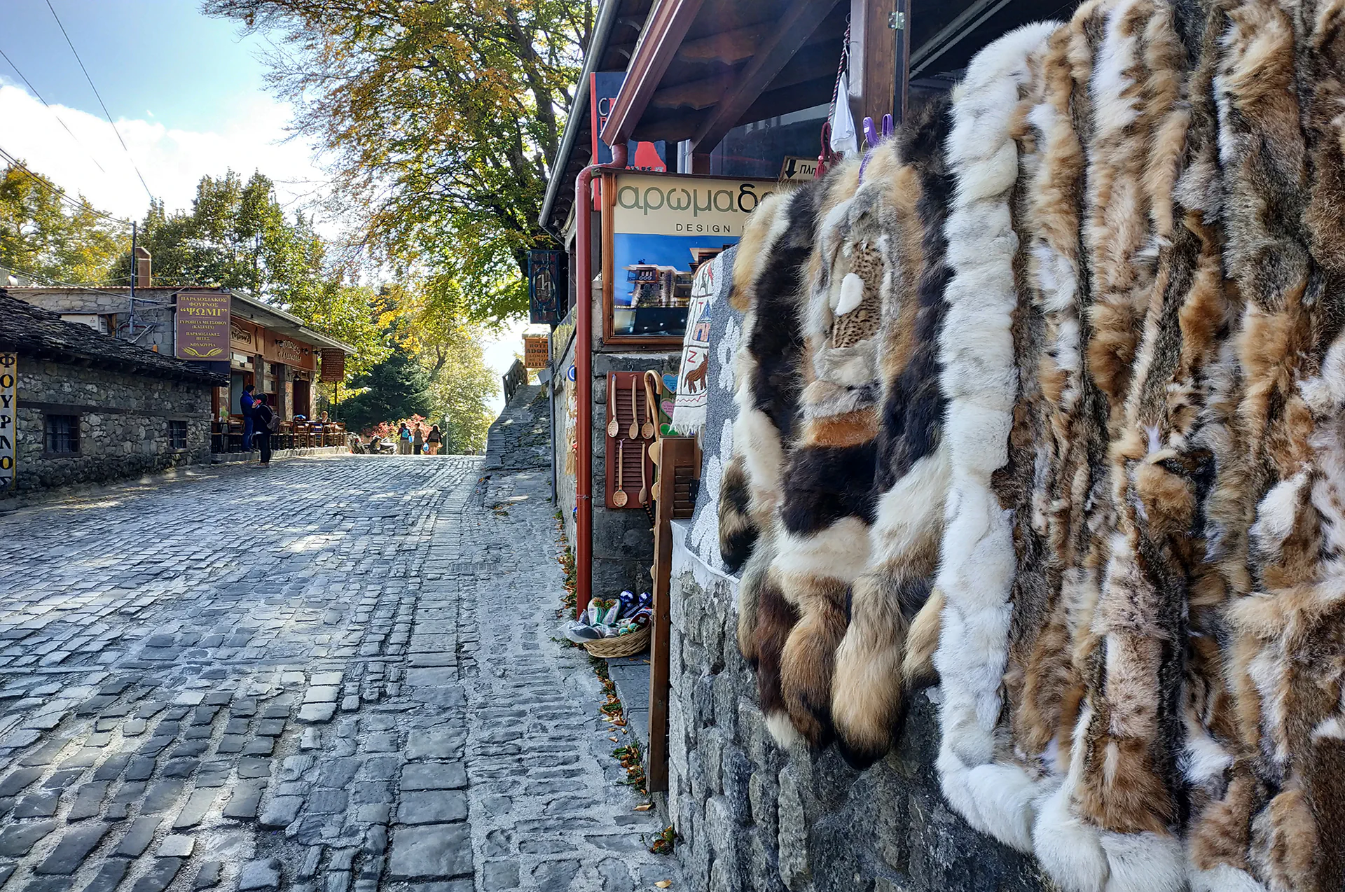 Handmade rugs and local crafts at a Metsovo market.