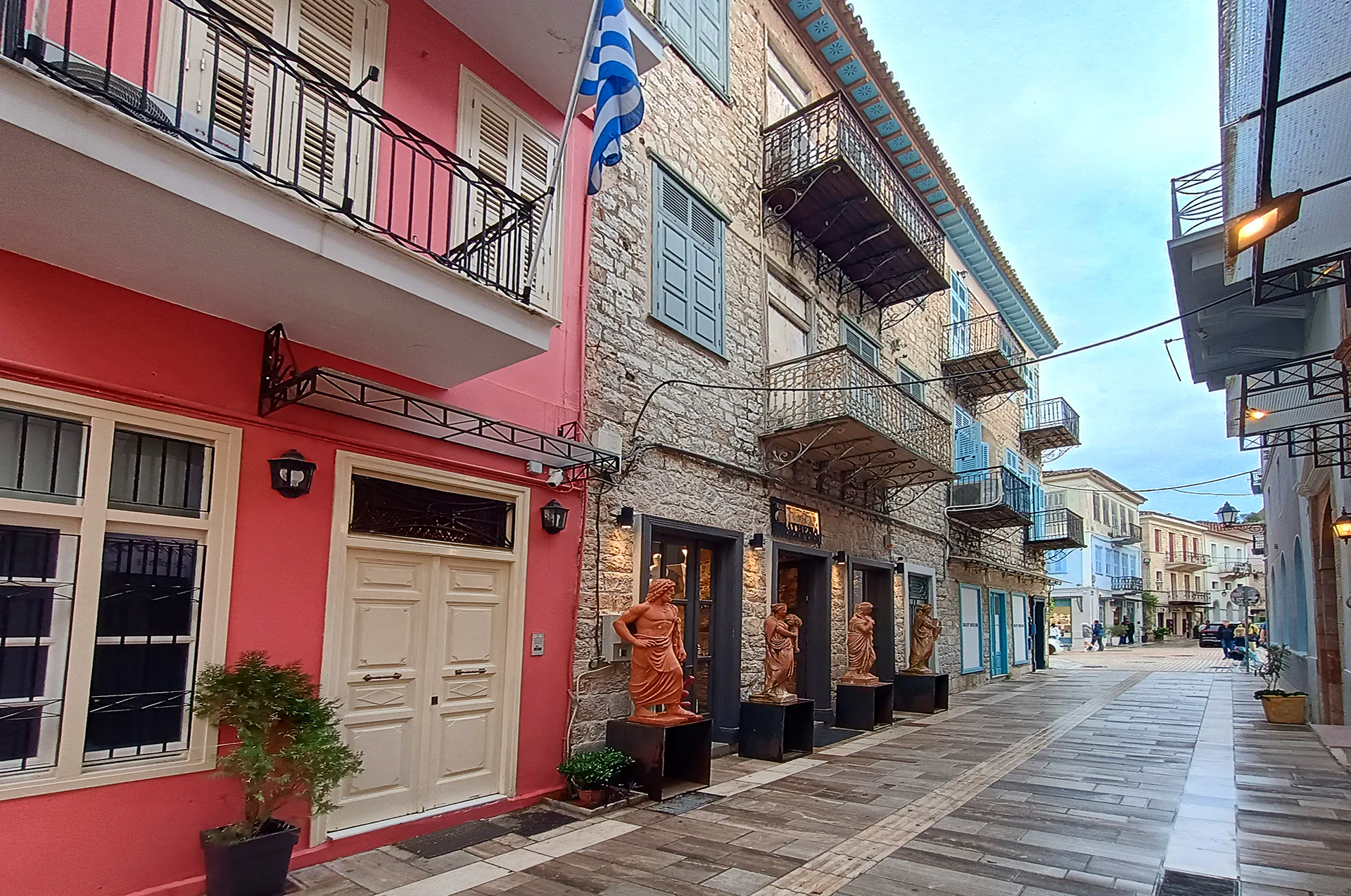 Narrow cobblestone street in Nafplion’s Old Town with colorful houses and balconies