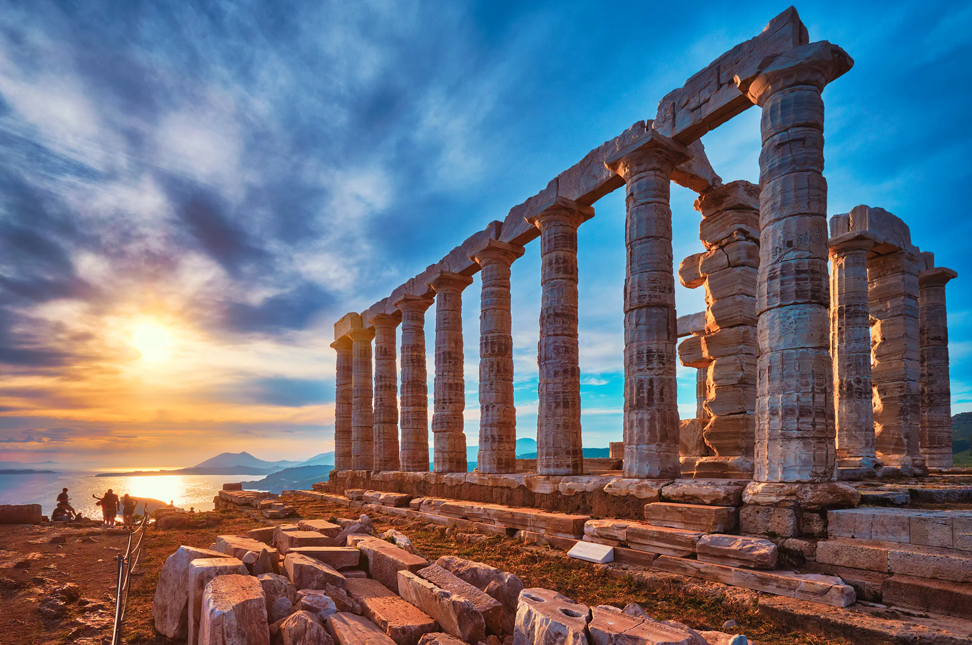 Temple remains illuminated by sunset at Cape Sounion